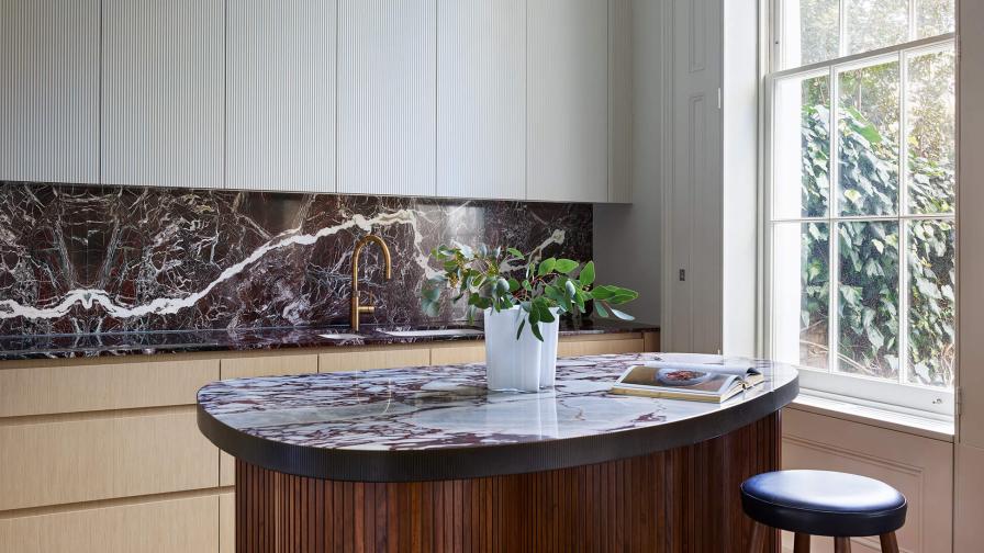 Angled view of a kitchen with a CTO pendant light and view through the window