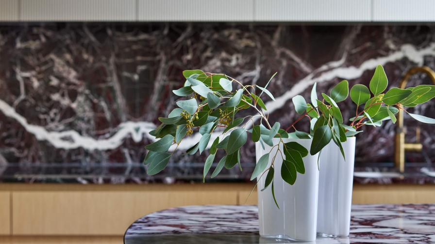 An Alvar Aalto glass vase sitting on the worktop of a kitchen island