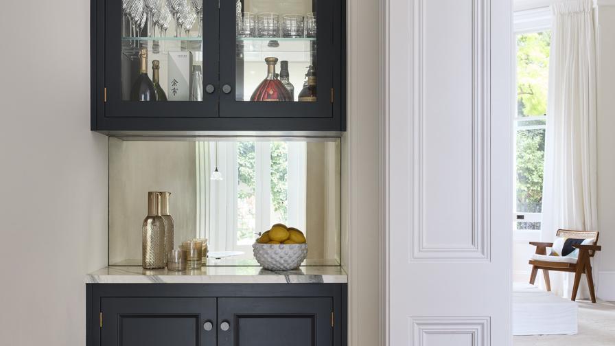 A single dark grey base unit with glazed unit above & mirrored backsplash 