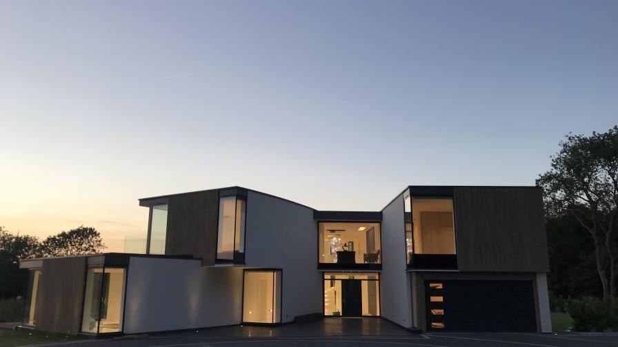 Shows home at dusk, with Lutron lighting.