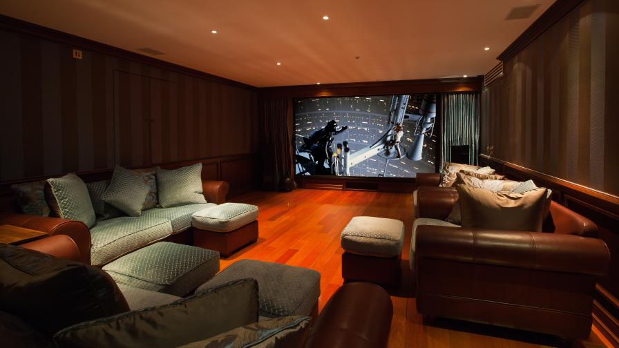 Home cinema, showing large screen with projected image of a Star Wars scene.