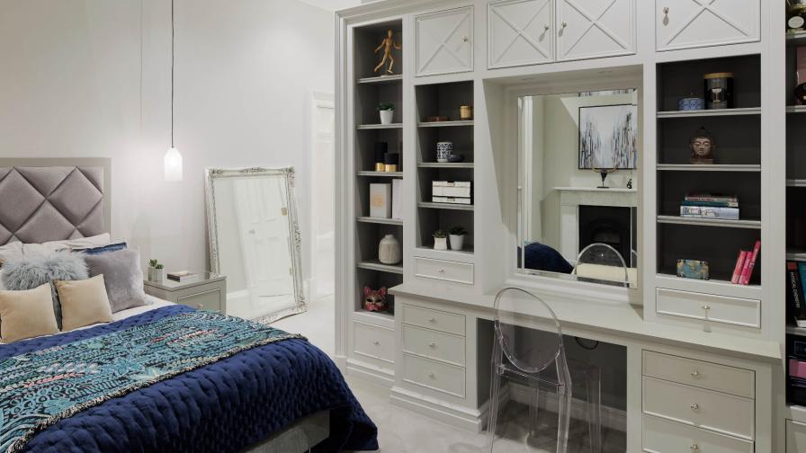 A white painted bedroom unit with dressing table by Hetherington Newman