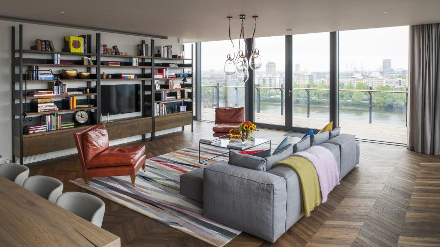 Apartment with view over the Thames river featuring a chevron timber floor.