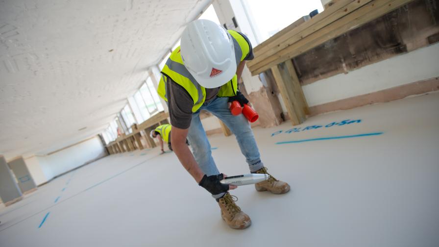 Using a Schimdt hammer to test the compressive strength of the floor. 