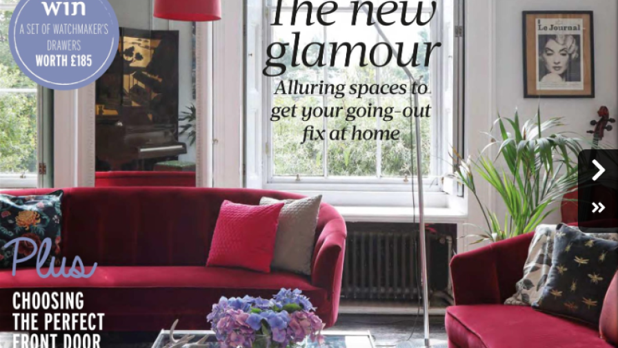 A pair of red sofas in a sitting room on the cover of Reclaim magazine