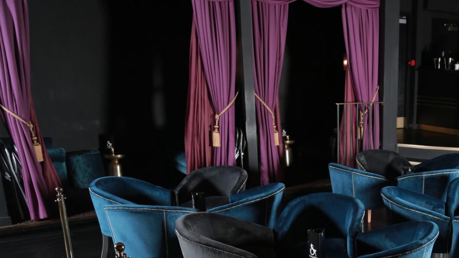 Blue and grey velvet arm chairs in club