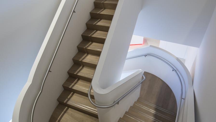 Fumed Oak Flooring clad to spiral stair case with polished metal grips