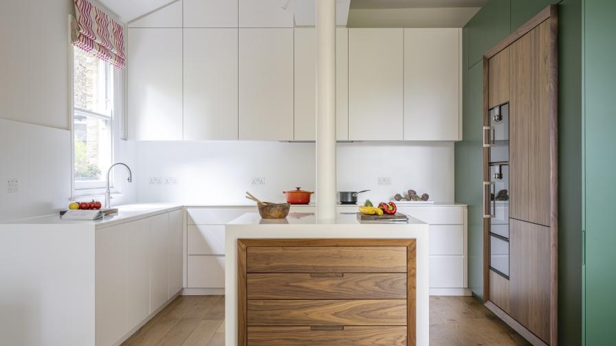 Bespoke kitchen with walnut highlights and a Corian worktop and island