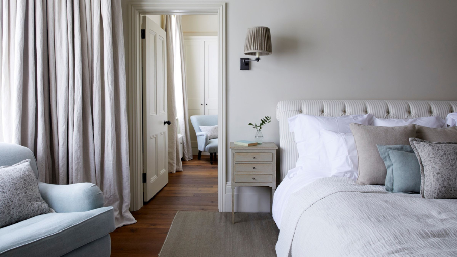 Interior of a bedroom with look into adjoining ensuite bathroom.