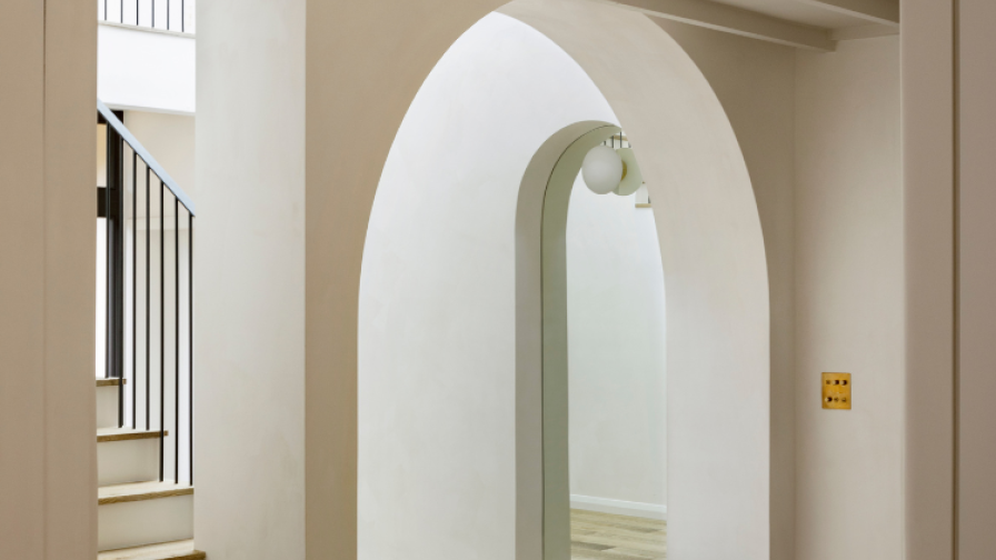 Entrance hall with arch, grey oak flooring and matching staircase.