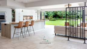 Kitchen overlooking the garden. Modern white and wood with tan furniture.